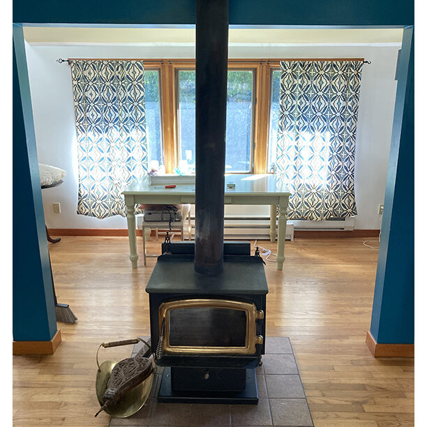 Free-standing wood stove in center of large room