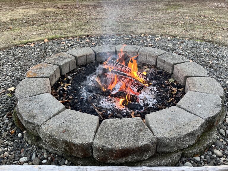 Small campfire set within paver-stone ring.